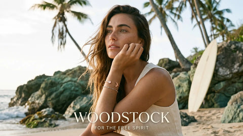 Woman wearing waterproof gold-plated stainless steel jewelry on the beach, travel-inspired jewelry collection for women, elegant vacation and adventure accessories