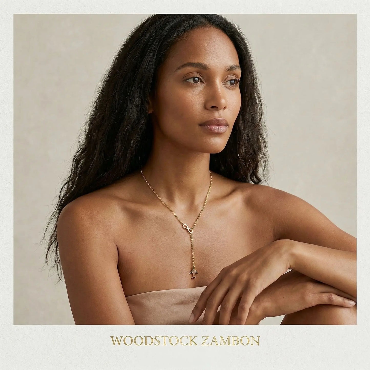 Woman wearing gold infinity necklace for women in minimal elegant setting