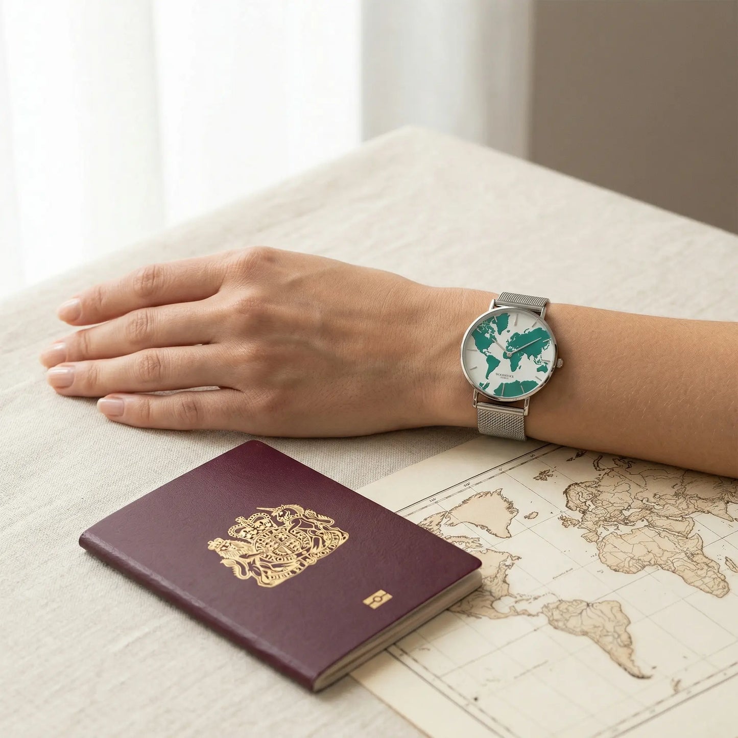 Women's waterproof watch with green reflective world map dial on mother of pearl background Woodstock Zambon worn on wrist