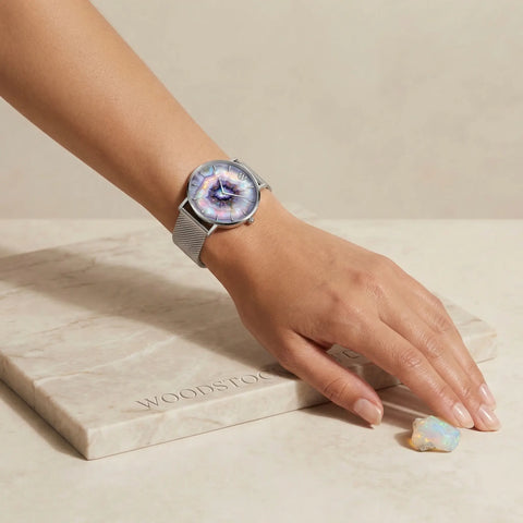 Woodstock Zambon Opale silver watch for women with iridescent dial on marble surface