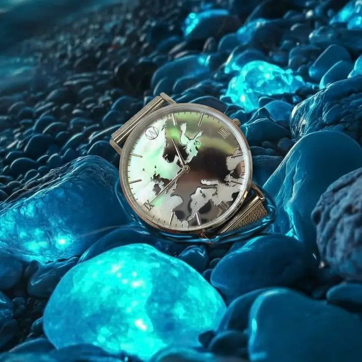 Glow in the dark mother of pearl world map watch unisex with reflective mirror dial on blue stones background