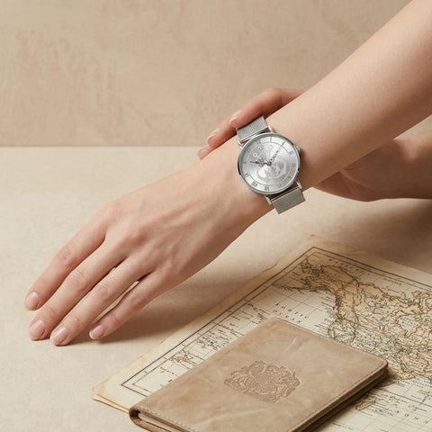 Elegant women's watch with anchor symbol by Woodstock Zambon on wrist with vintage map and passport