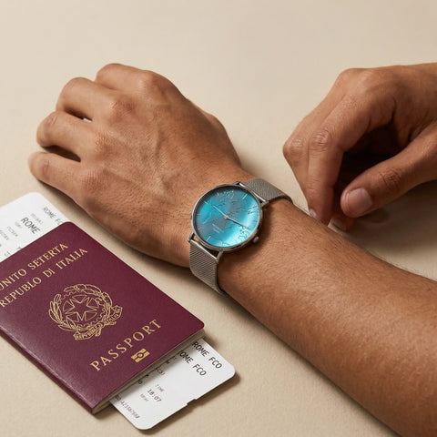 Men's waterproof watch with turquoise reflective world map dial Woodstock Zambon worn on wrist with passport