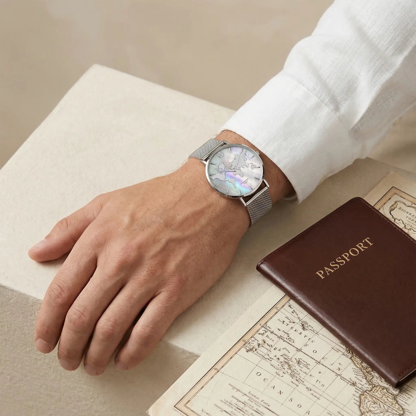 Men's waterproof watch with reflective metallic world map dial on mother of pearl background Woodstock Zambon worn on wrist