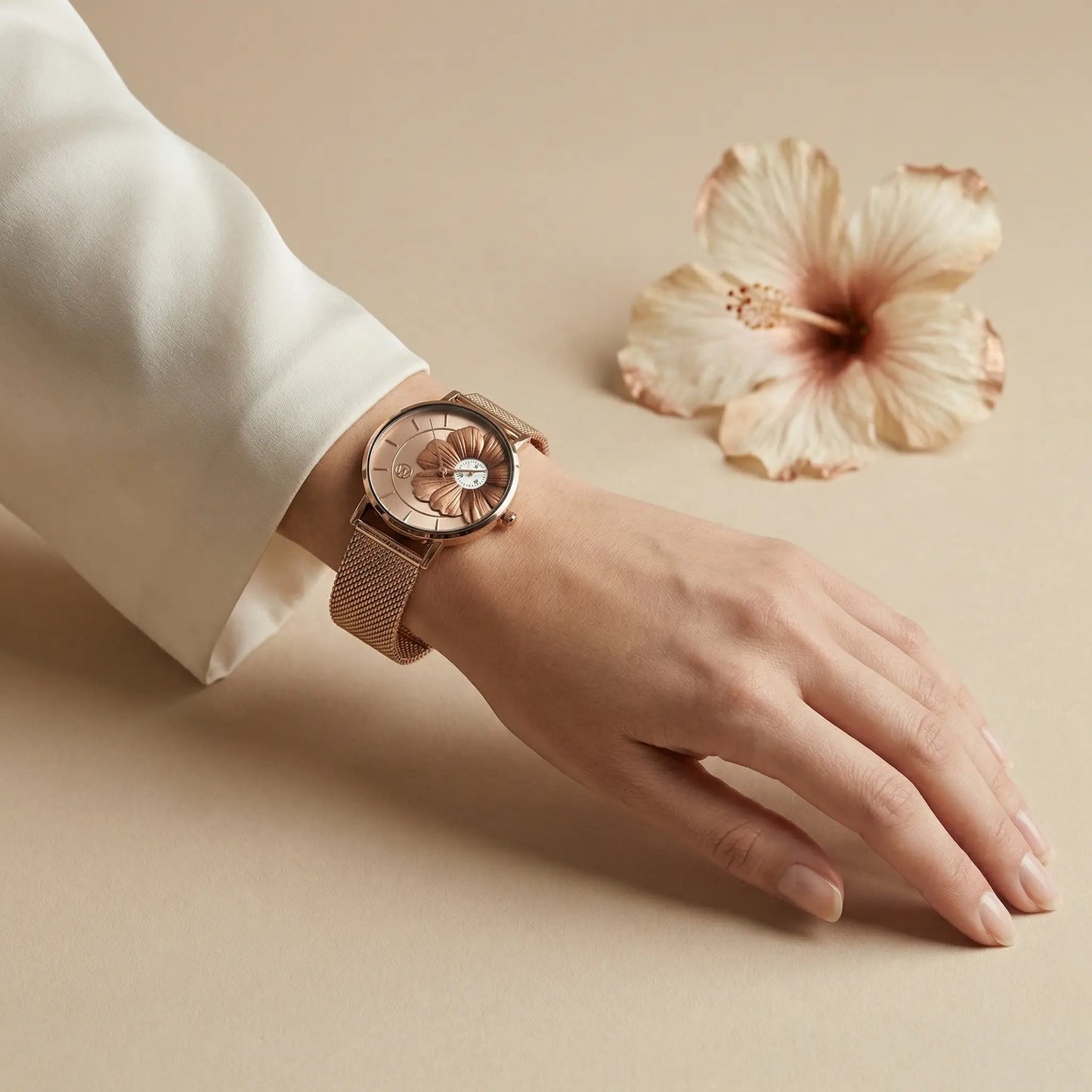 Women's rose gold hibiscus flower watch Woodstock Zambon worn on wrist with soft neutral background