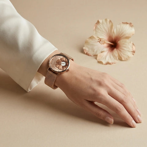 Women's rose gold hibiscus flower watch Woodstock Zambon worn on wrist with soft neutral background