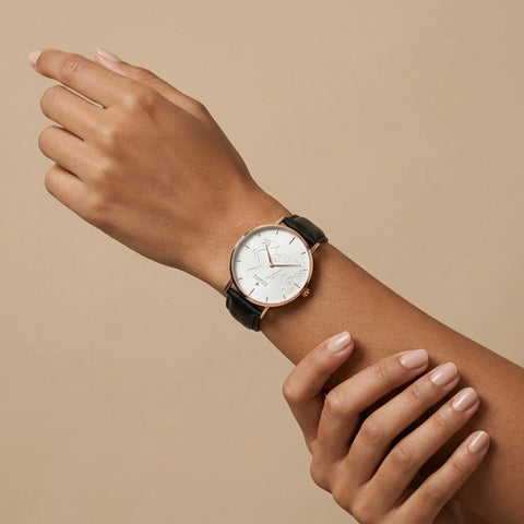 Elegant white minimalist world map watch with rose gold case and leather strap by Woodstock Zambon worn on wrist